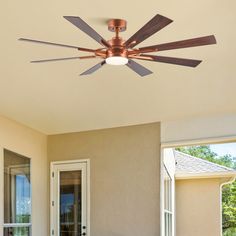 a ceiling fan that is on the outside of a house