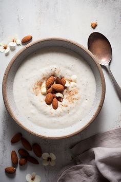 a bowl filled with oatmeal and nuts on top of a table