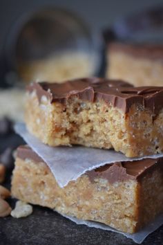 two pieces of cake sitting on top of each other next to nuts and a spoon