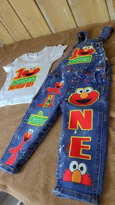 two children's sesame street jeans and one t - shirt