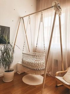 a room with a swing, chair and potted plant