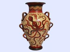 an octopus painted on the side of a red and white vase with brown trimmings