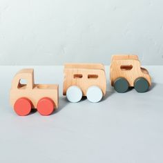 three wooden toy trucks sitting next to each other