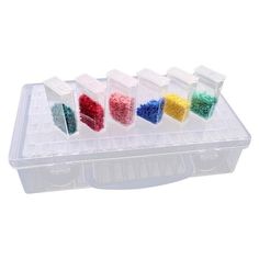 four plastic containers filled with different colored beads