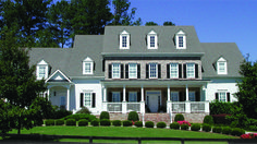 a large white house with black shutters and windows