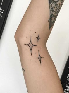 a woman's arm with three stars on it