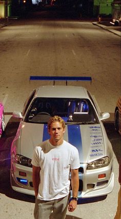 a man standing next to a parked car