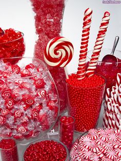 many candy canes and candies in glass containers