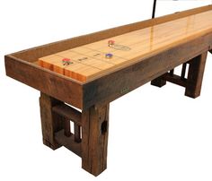 an old wooden table with two benches on one side and several game pieces on the other