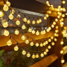 some lights that are hanging on a fence