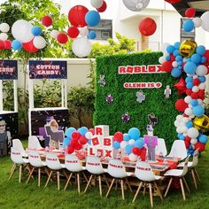 an outdoor party with balloons and decorations