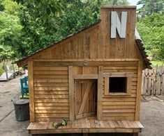 a dog house made out of wooden boards