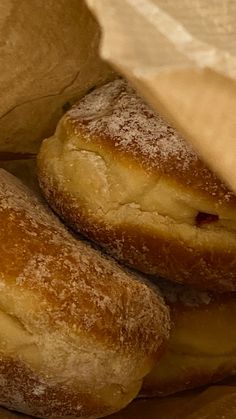 three bagels stacked on top of each other with powdered sugar sprinkled on them