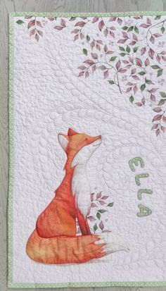 a red fox sitting on top of a white quilt