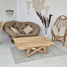 a living room filled with furniture and hanging decorations on the wall next to a coffee table