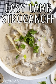 an image of a bowl of soup with mushrooms and parsley in it on a table