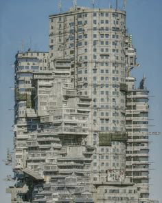 a very tall building with lots of windows and balconies on the top floor