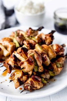 chicken and broccoli skewers on a white plate