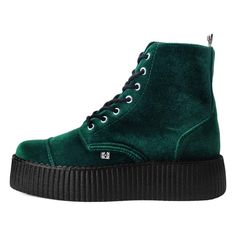 a pair of green shoes with black soles on the top and bottom, all in suede