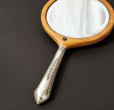 a magnifying glass sitting on top of a black table next to a mirror