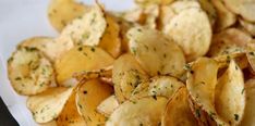 a pile of potato chips sitting on top of a white plate