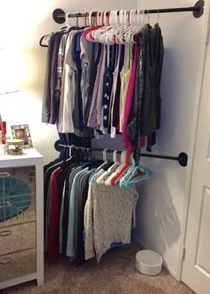 a closet with clothes hanging on the wall