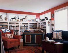 a living room filled with lots of furniture and bookshelves full of different types of books