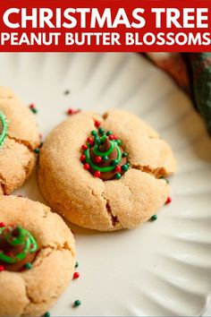 three christmas tree peanut butter blossoms on a white plate