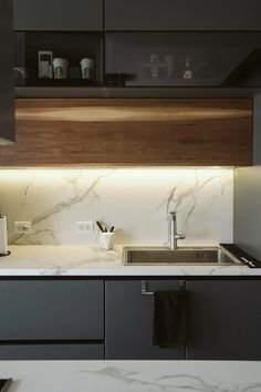 a kitchen with marble counter tops and cabinets