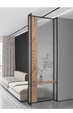 a room divider is open to reveal a living area with couches and a plant