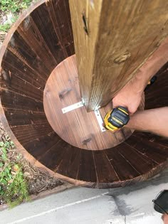 a man is using a drill to repair a piece of wood that has been cut in half