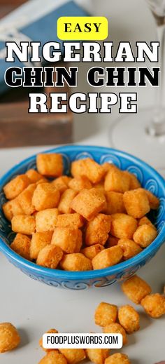 a blue bowl filled with cheesy tater tots on top of a table