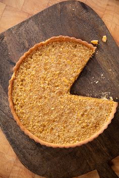 a piece of pie sitting on top of a wooden cutting board