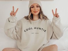 "Show off your inner cool auntie style with this stylish and customizable sweatshirt. Featuring a minimalist design, this cozy crewneck is perfect for everyday, and it can be personalized with your custom year to make it even more special! Also makes for the most perfect way to share the news with your fave auntie or auntie to be too! * All our sweaters are made using the incredibly cozy and ultra popular Gildan 18000 Sweater and are UNISEX sizing.  * Please refer to the size charts we've includ Ski Outfits For Women, Bride Sweatshirt, Trendy Bride, Dance Mom, Future Mrs, Sedona Arizona, Hem Design, Doberman Pinscher