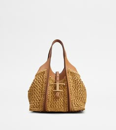 Shopping bag with flowing lines, crafted in raffia with fine crochet detailing and leather inserts. Characterized by the branded metal T Timeless pendant accessory, it comes with two fixed handles, adjustable and removable shoulder strap, internal pouch. Leather Zip Pouch, Tods Bag, Timeless Bags, Timeless Wardrobe Staples, Raffia Bag, Woven Raffia, Desert Boots, Medium Tote, Shopping Tote Bag