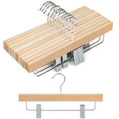 a wooden shelf with clothes hangers attached to it and two metal hooks on each side