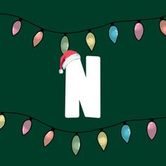 the letter n is decorated with christmas lights and a santa's hat on it