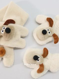 three stuffed animals are laying next to each other on a white surface with black eyes and brown ears