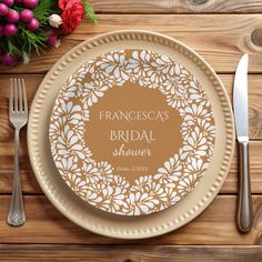 a plate with a name on it next to silverware and flowers