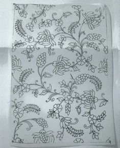 a piece of paper with flowers and vines drawn on it's side in black ink