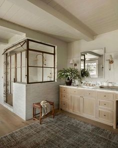 a large bathroom with two sinks and mirrors