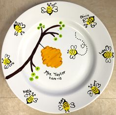 a white plate with yellow and brown bees on it