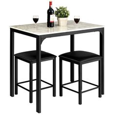 a table with two stools and a bottle of wine next to it on a white background