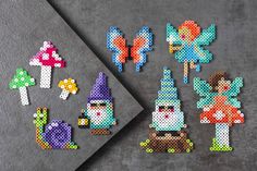 the pixel art project is being made with different colored beads and plastic pegs to make it look like they are from fairy land