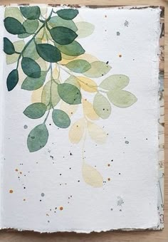 a piece of paper with leaves painted on it