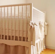 a baby crib with ruffles and bows on it