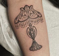 a tattoo on the arm of a person with a lamp in front of her head