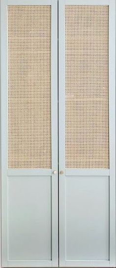 a blue armoire with wicker panels on the front and back doors, against a white wall