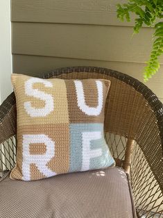 a pillow sitting on top of a wicker chair