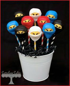 there are many cake pops with faces on them in the cupcakes and candy sticks